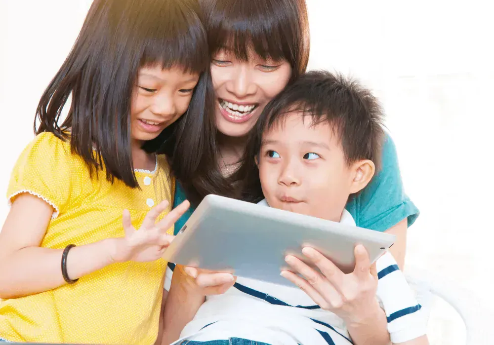 Happy mum and children using an ipad