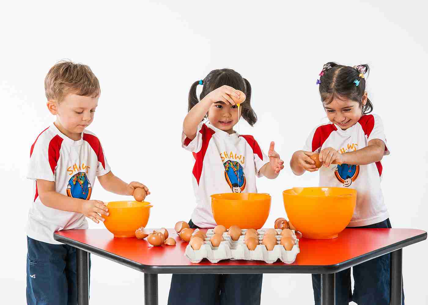 children having fun cracking eggs