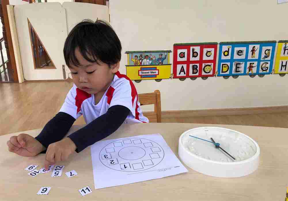 boy learning to tell time maths