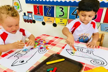 A child making art at Shaws Preschool